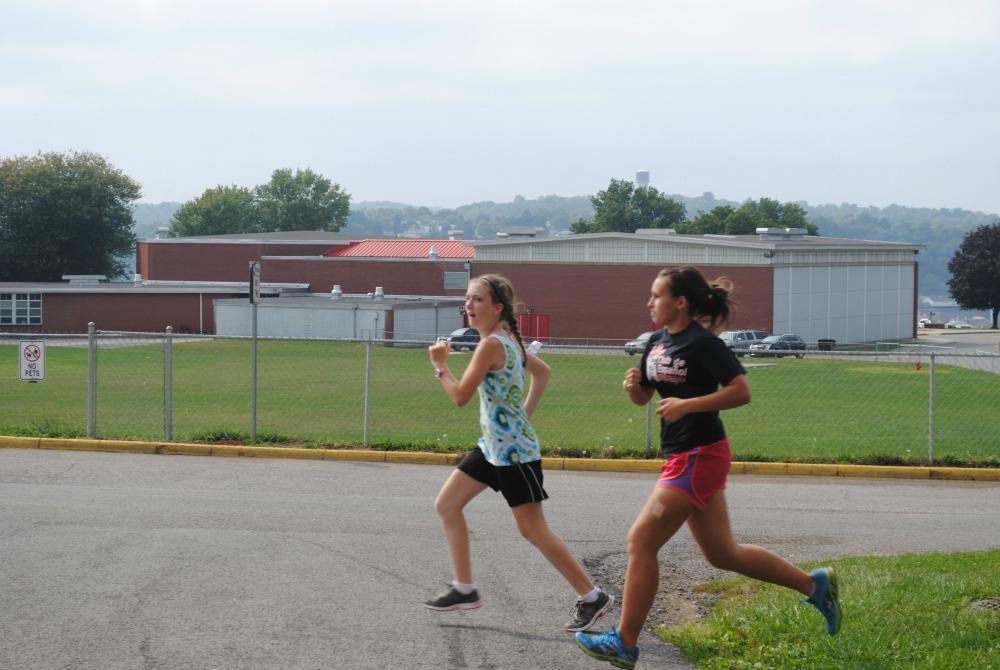 Freshman Madeline Kiefer and Junior Kayleigh Roberts run during practice after school.