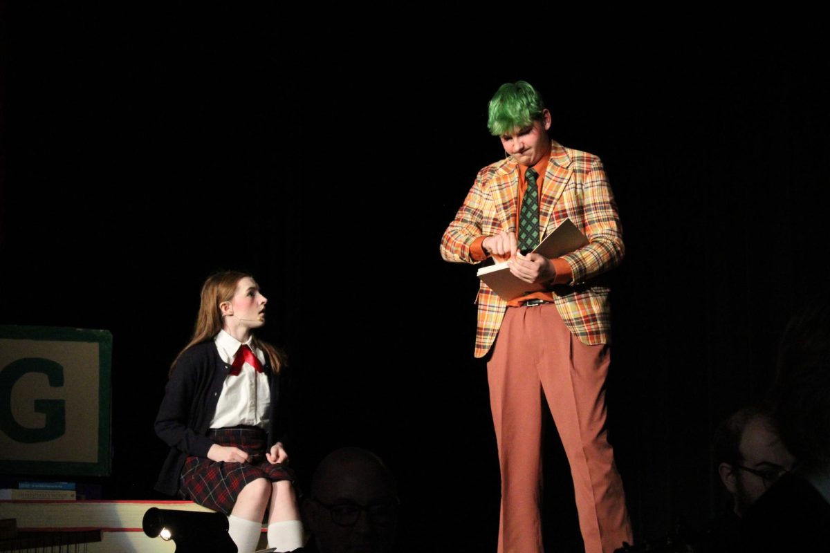Rising star: Playing Mr. Wormwood, junior Christopher Denkovich acts out a scene during the musical. Even though it was his first year in the musical, Denkovich was casted in a leading role.
