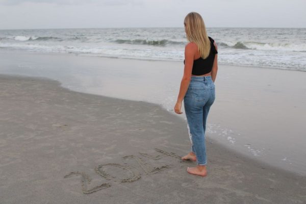 Last goodbye: Writing in the sand, senior Madison Meyer takes one last vacation to the beach with her family before college. Spending quality time with family is important to allow the bonds to grow tighter.