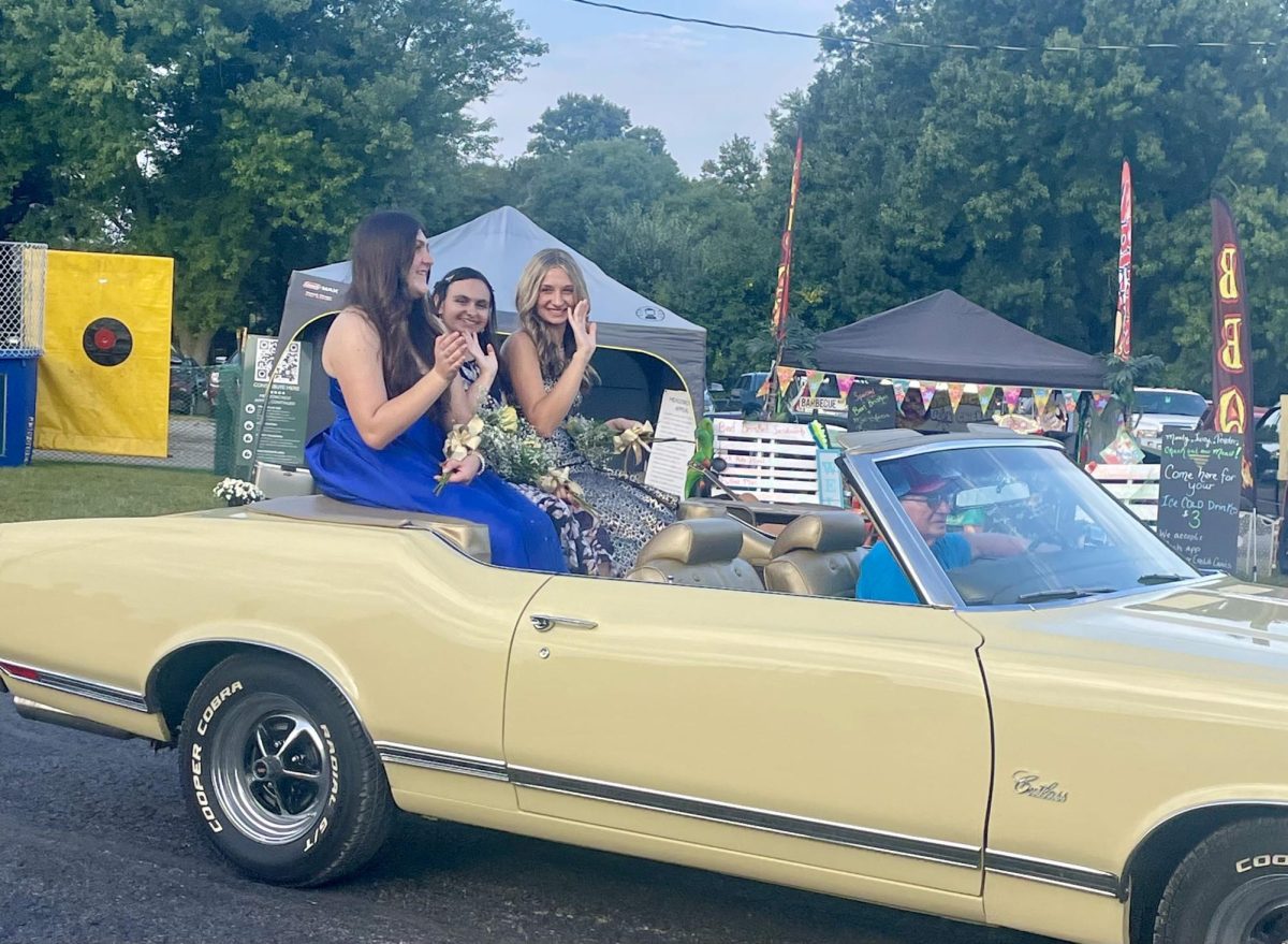 Royal treatment: Smiling and waving, the Big Knob Fair Queen contestants ride in a convertible during the
annual fair parade on Aug. 27. All of the candidates were required to dress up and participate in pageant-style
activities during the contest.