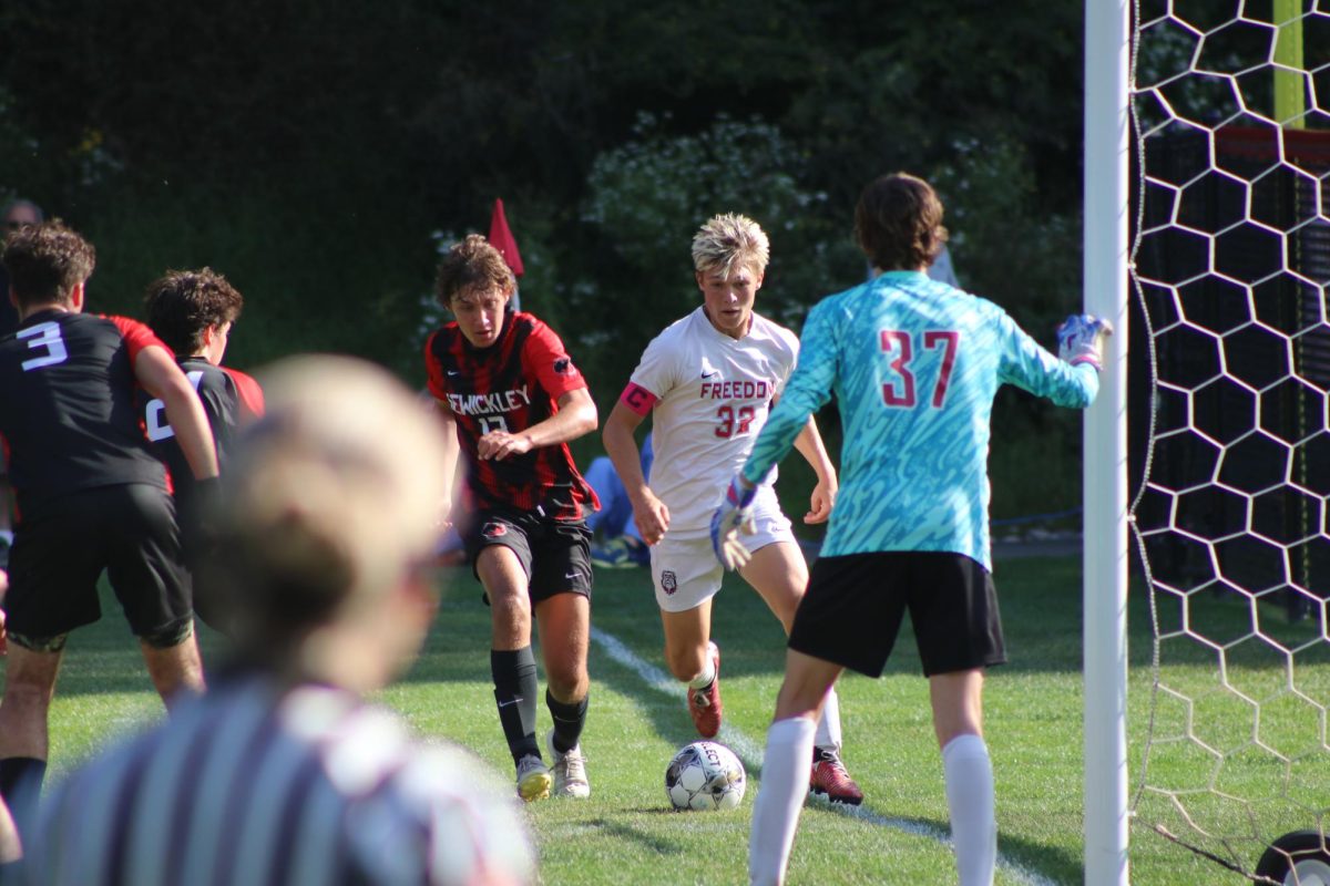 In position: Running toward the goal from the outside corner, Jordan Delon (12) makes an effort to take a shot on goal on Sept. 10, at Sewickely Academy. Their win against Sewickely Academy broke their streak of losing to the team.