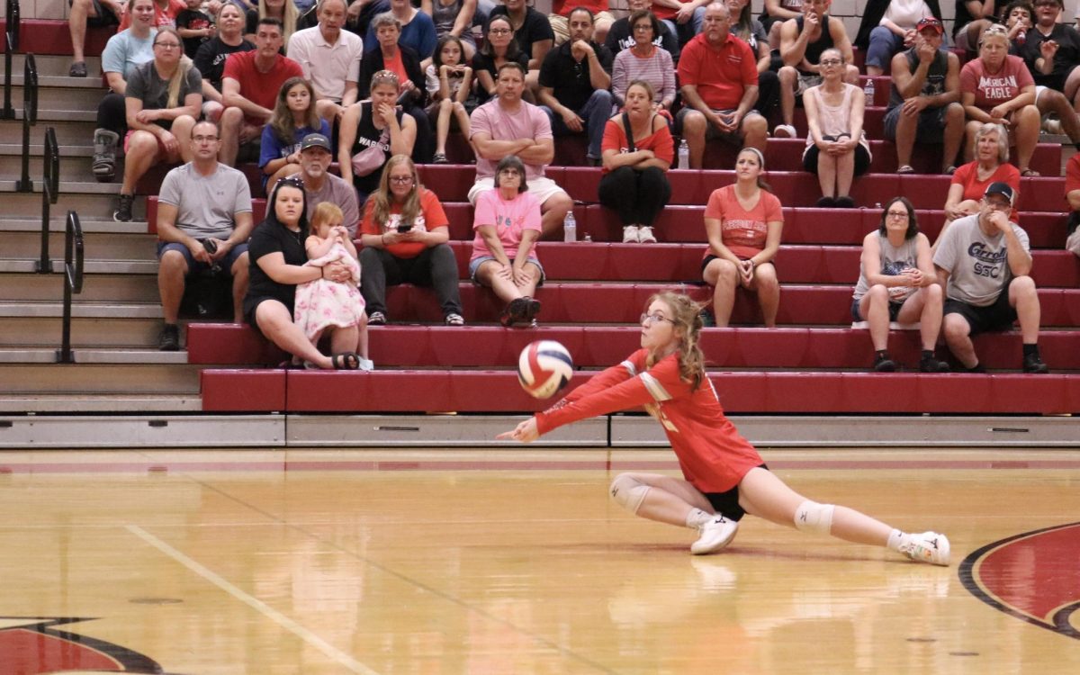 Diving play: Diving, Tessa Wright (10) tries to save the ball from hitting the floor in an intense rally. In volleyball defense is one of the most important factors in winning a game.