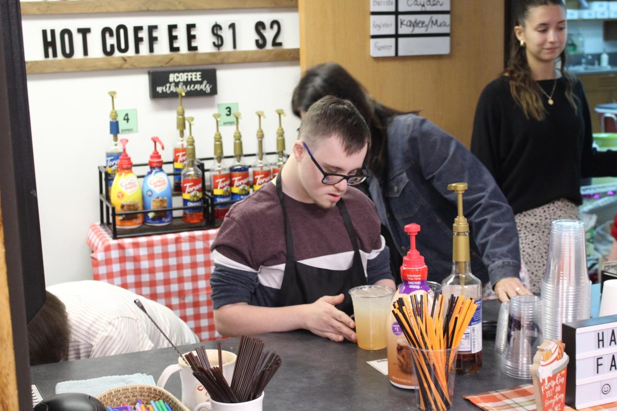 Fabulous flavor: Looking at the lemonade, Cayden Signorelli (11) ensures that the drink is perfect for the customers. The cafe’s specialty lemonade is one of there most popular items for students to purchase.