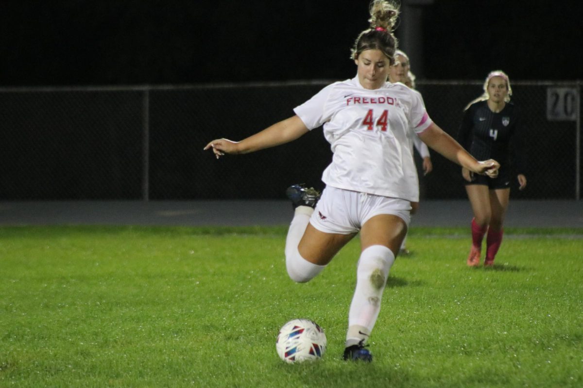 On a roll: Winding up for a kick, Brianne Casto (11) aims to kick the ball up the field. Casto will kick the ball up the field to her teammates to help aid them into scoring a goal.