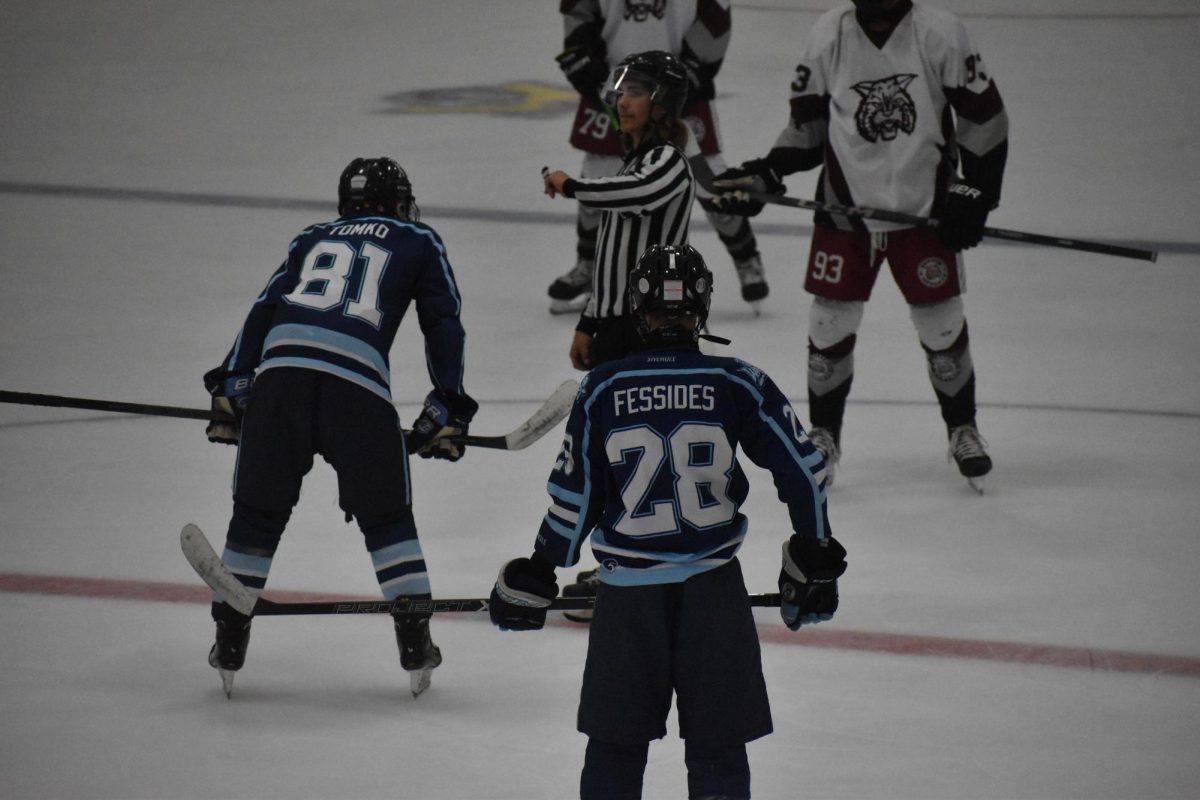 Taking Aim: Noah Fessides (12) stands on teammate Kevin Tomko’s right wing in the face-off circle, waiting for the puck to drop. Central Valley finished their pre-season campaign with a 0-1-2 record before the official start at the beginning of October.
