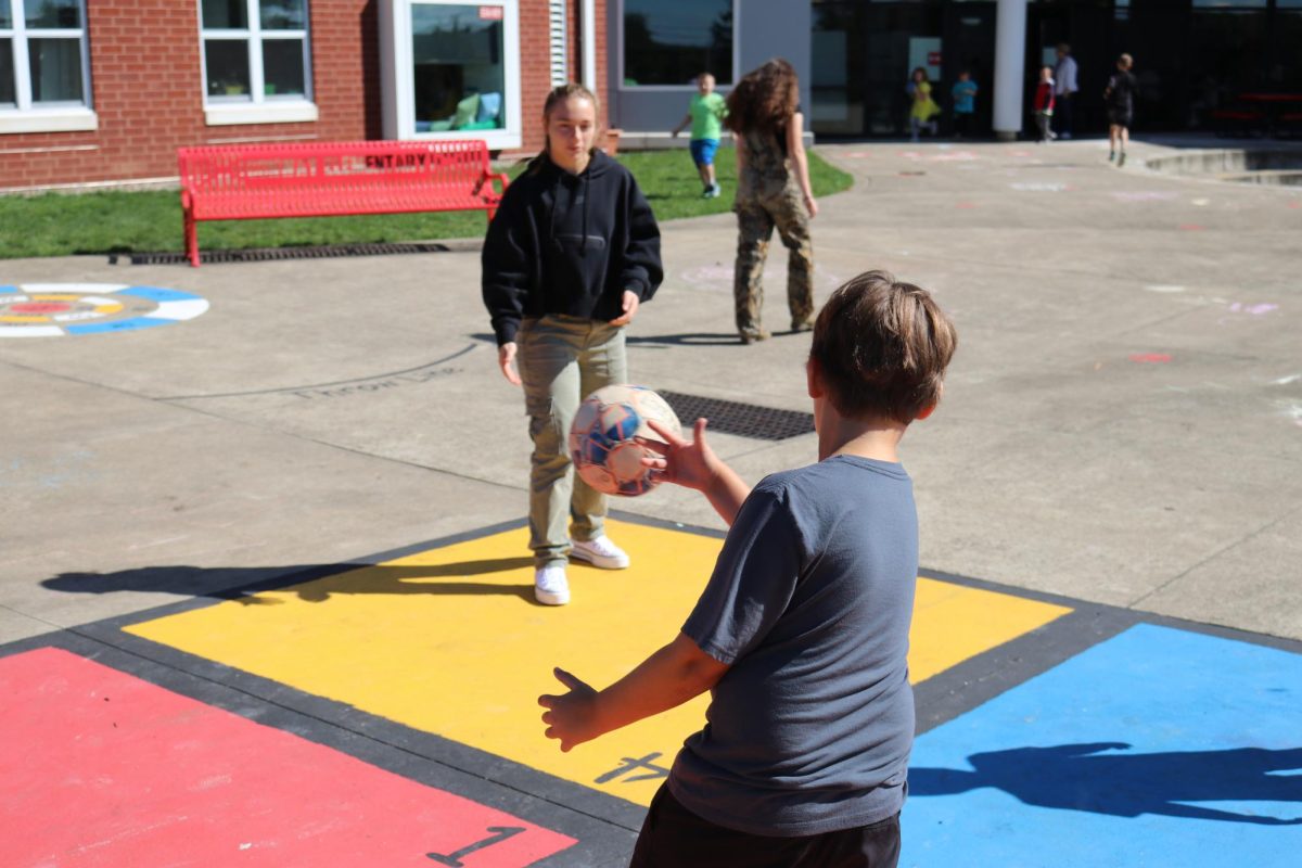 Big impact: In the foursquare court, Alyssa Bearer (11) and her Little play outside together. Doing activities together is one of the many ways Bigs bond with their Littles.