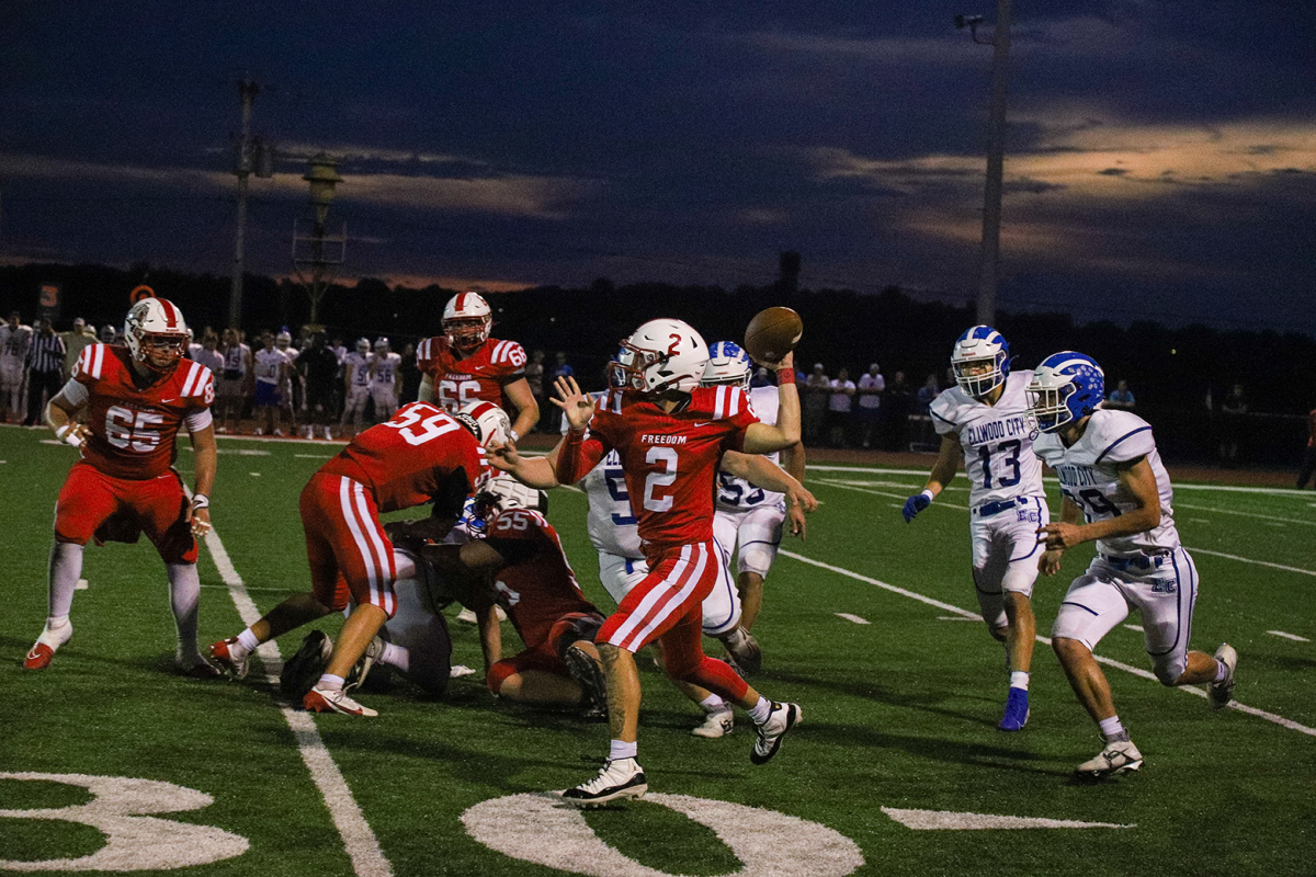 Winning pass: Running, Isaiah Leasha (12) runs down the field while attempting to make a pass. Freedom lost to Ellwood City 43-3 this game.