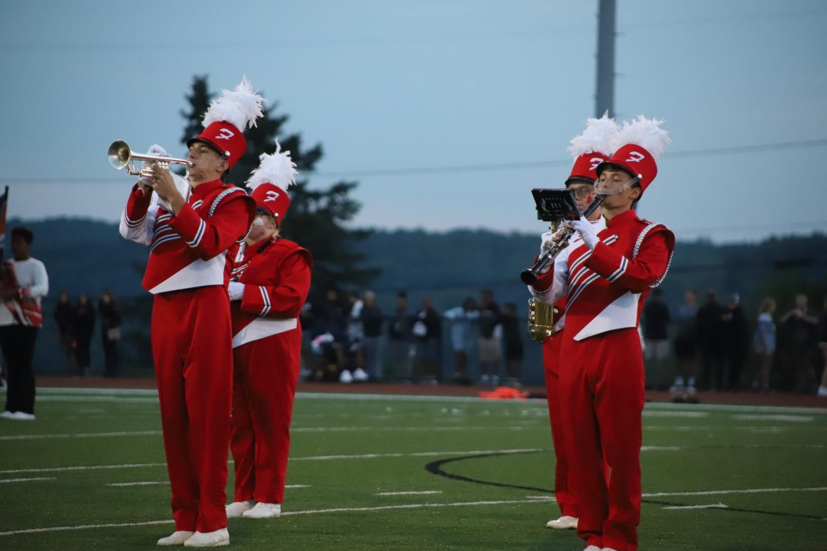 March on: Focused on their performance, Elias Boyd (12) and Joseph Castelli (12) play during the halftime show on Aug. 23. Each instrumentalist is a key factor to an extravagant halftime show.