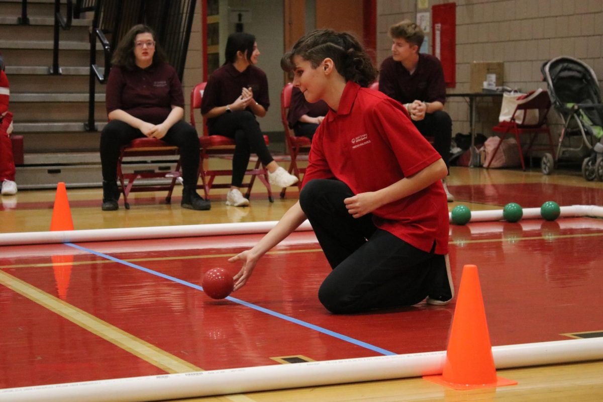 Bocce brilliance:  Leaning in, Hailey Stinar (12) carefully rolls the bocce ball towards the pallina. The Bulldog bocce team placed 2nd out of 106 teams in their district last season.  