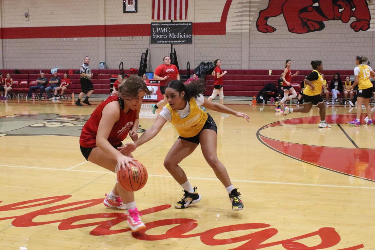 Offense on: At an attempt to sweep away the ball, Brianne Casto (11) has all of her attention on trying to get around her opponent. She is then ready to see which of her teammates are open.

